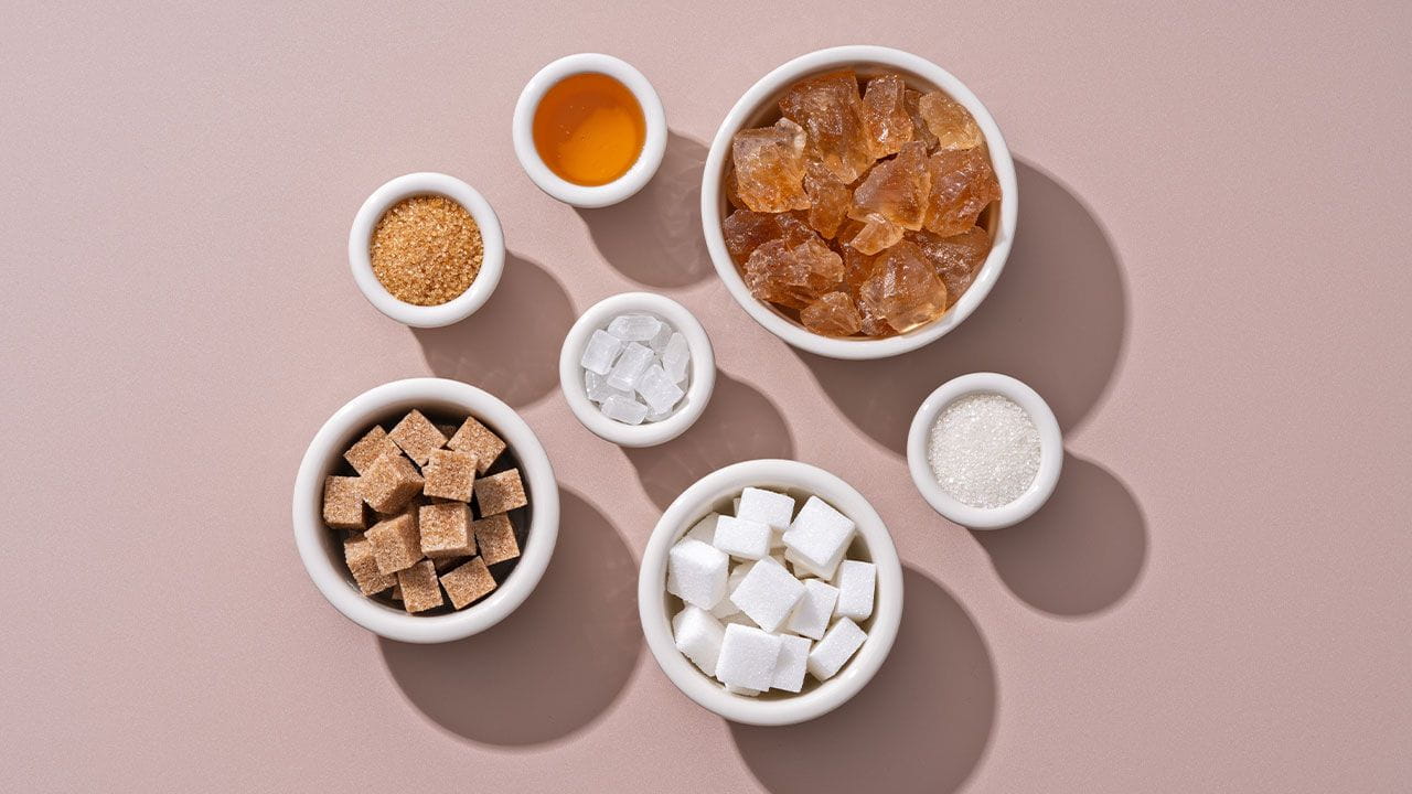 Cups filled with various artificial sweetener options. 