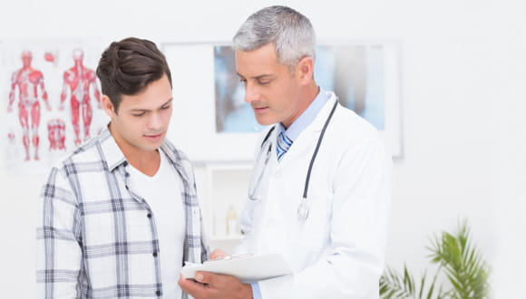 Young man talking with doctor