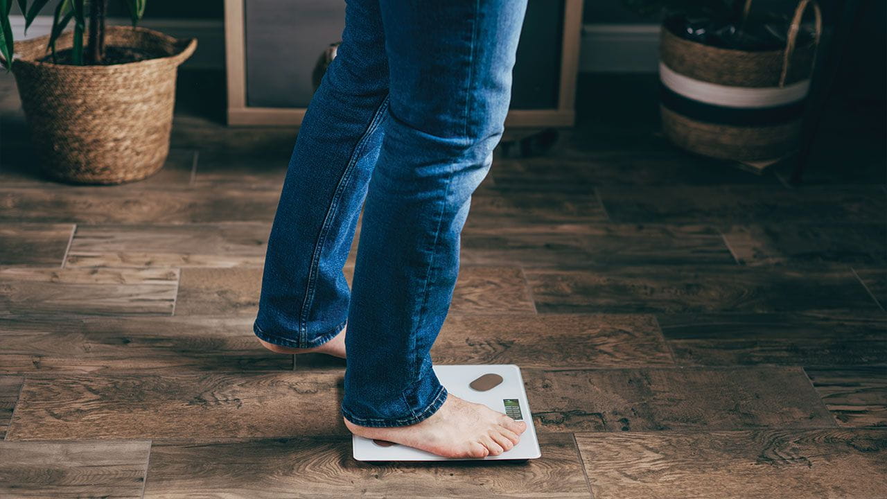 person stepping on a scale