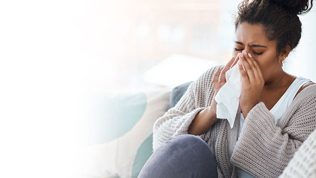 person blowing their nose