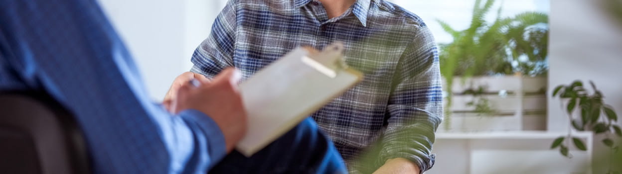cut out of a person talking to a therapist