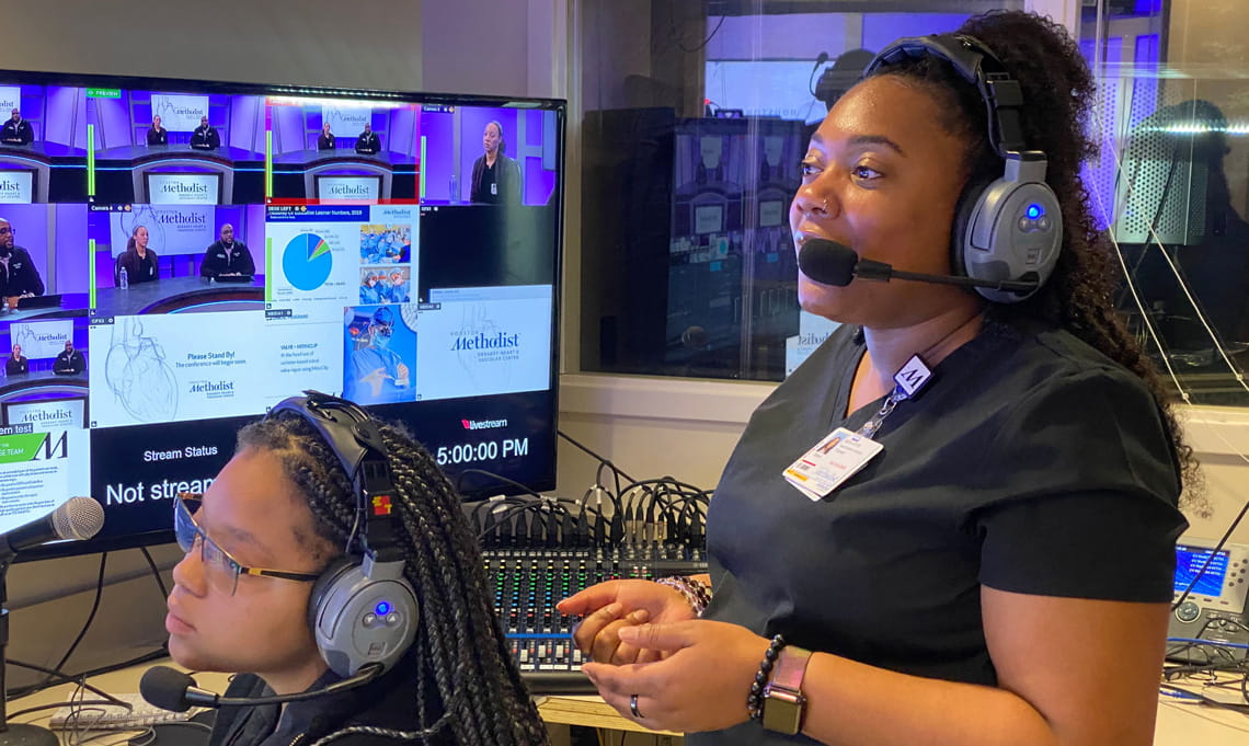 two video production interns with headsets on