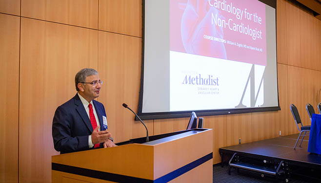 Dr. William Zoghbi stands at the podium speaking to attendees at the beginning of the Cardiology for the Non-Cardiologist conference