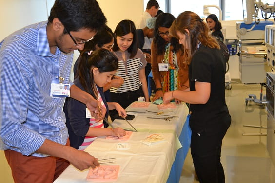 Students practicing suture techniques