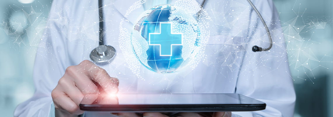 doctor holding ipad device with floating world graphic with medical symbol above it