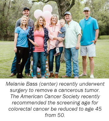 Melanie Bass (center) recently underwent  surgery to remove a cancerous tumor.  The American Cancer Society recently  recommended the screening age for  colorectal cancer be reduced to age 45  from 50.