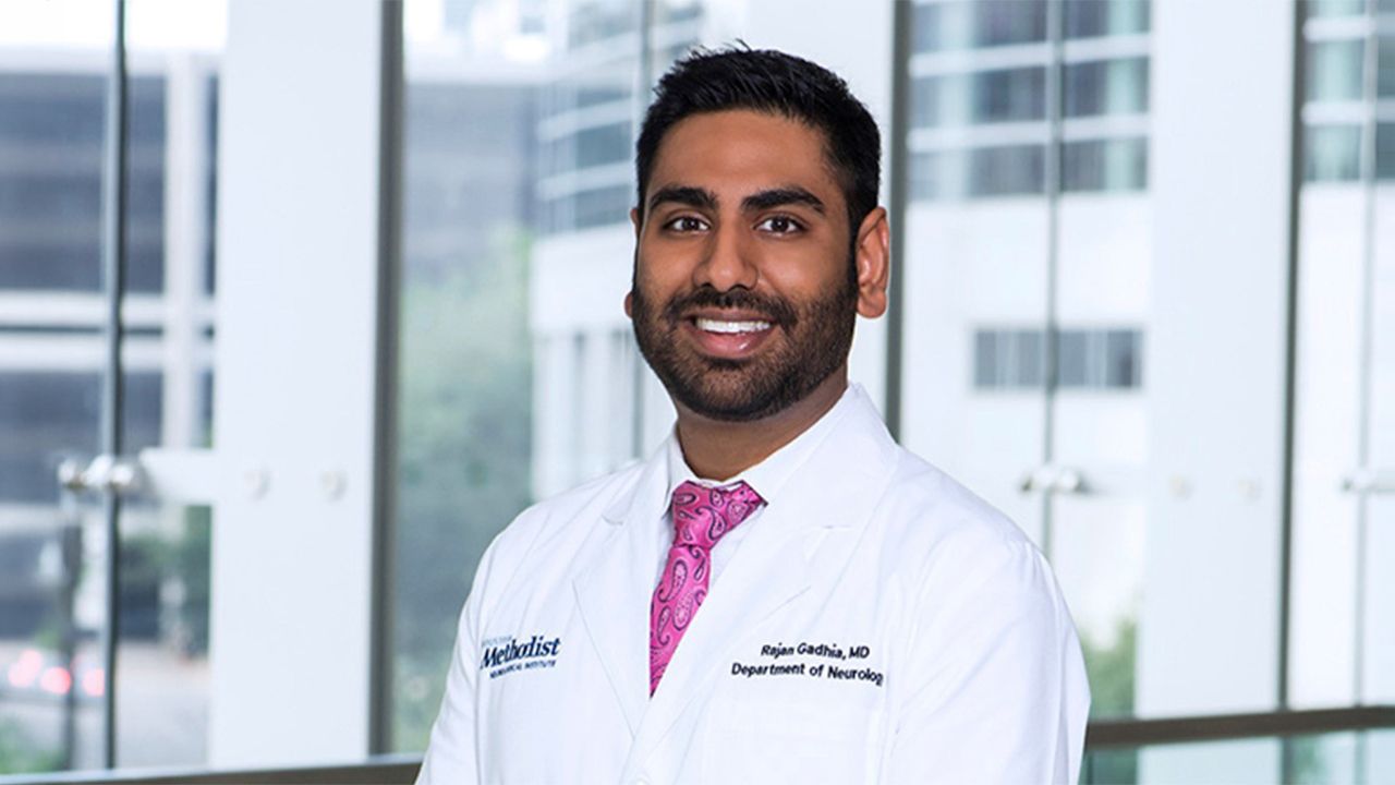 Portrait of Houston Methodist physician Rajan Gadhia in a white coat standing in front of a window.