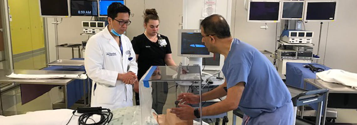 Faisal N. Masud  shows Steven H. Hsu the Houston Methodist Aerosol Container