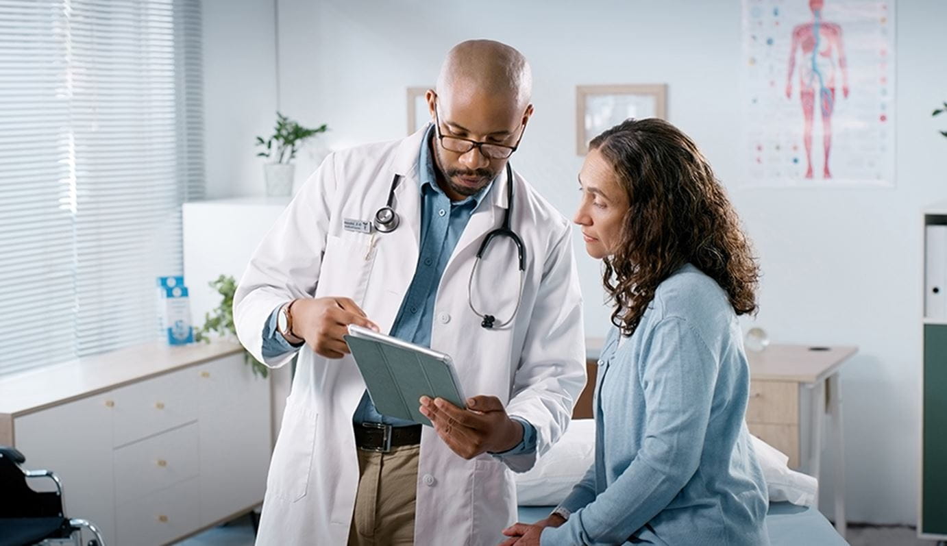 Doctor looking at a chart with a patient