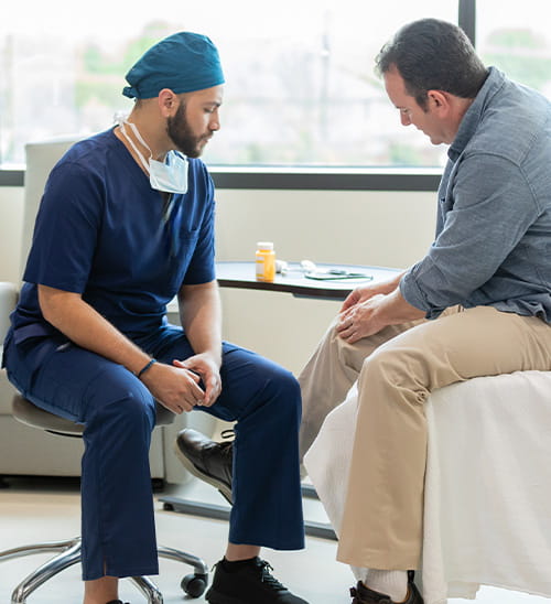 Healthcare professional and patient discussing treatment options during a medical office visit.