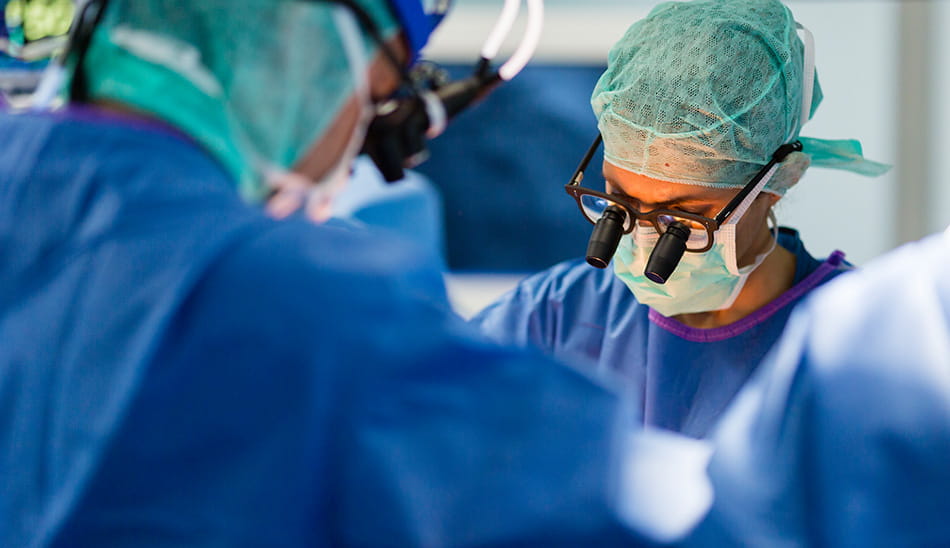 Doctor and surgical team performing surgery in an operating room.