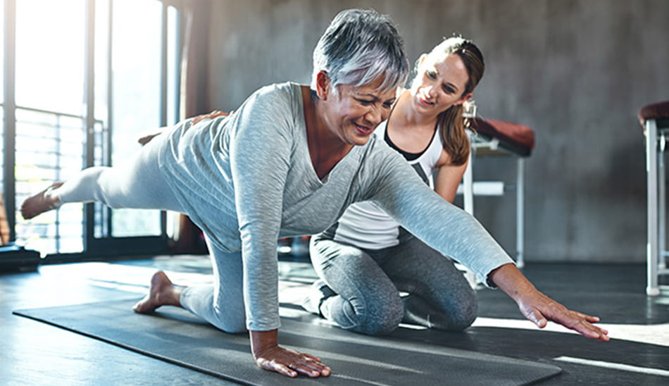 Woman exercising with a physical therapist