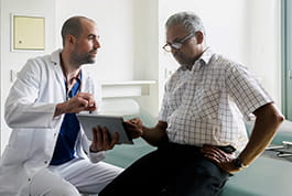 Male physician discusses heart failure with his older male patient