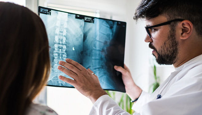 doctor viewing spine xray
