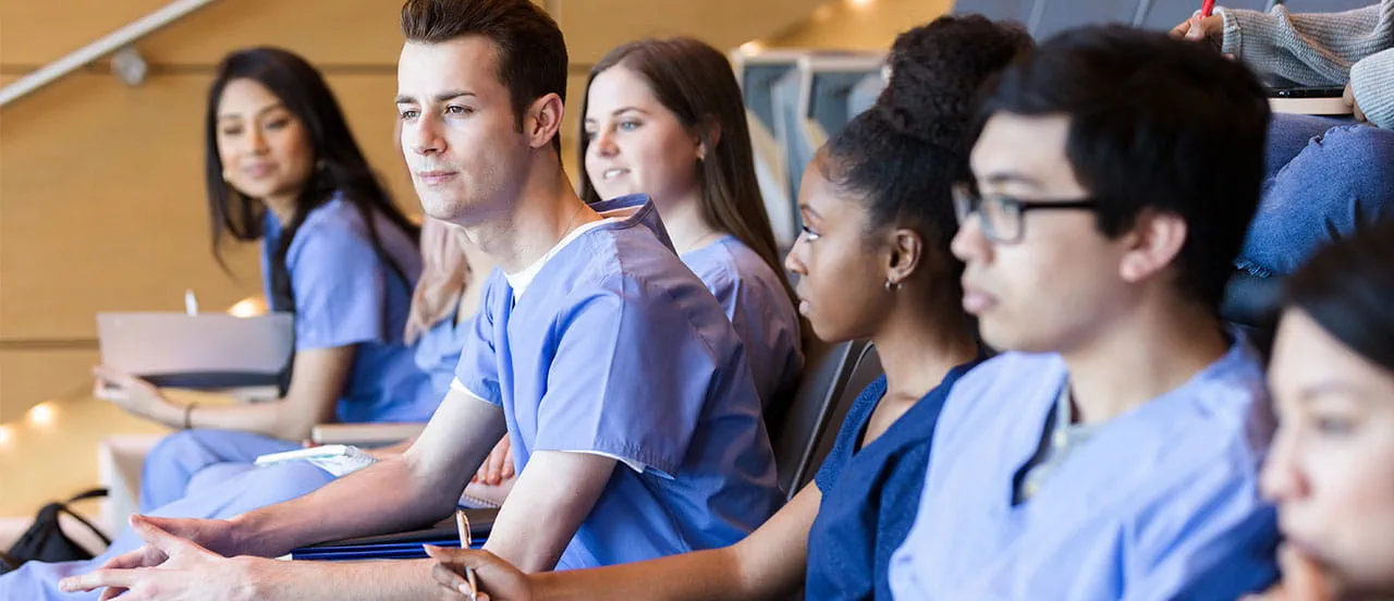 row of medical students in a lecture hall