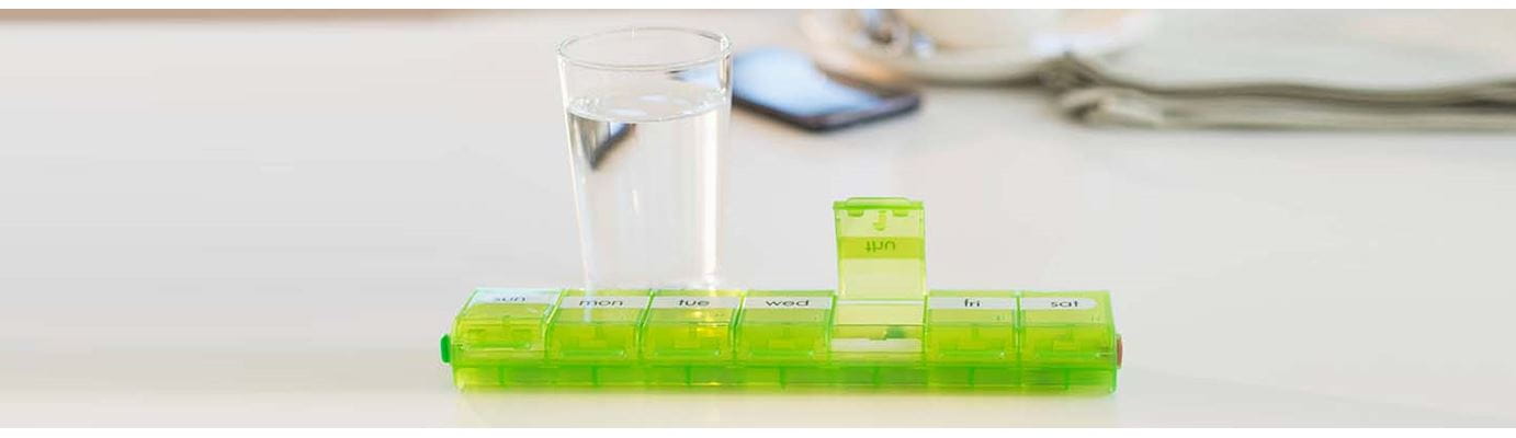 Pill organizer and glass of water
