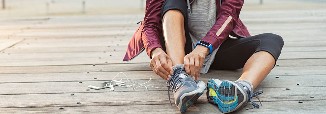 Women tying her running shoes