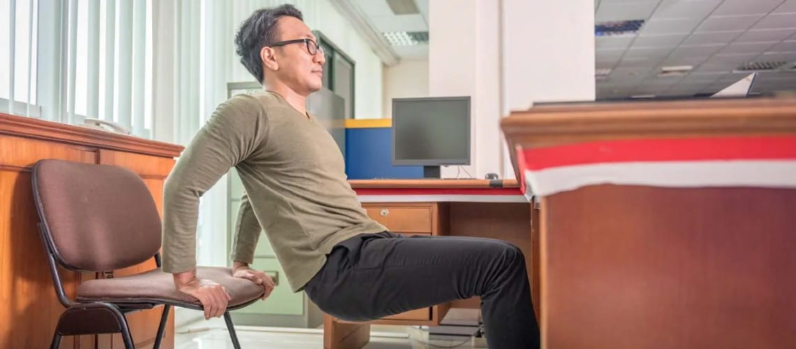 Man exercising at his desk