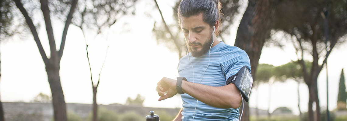 Man on bike checking smart watch